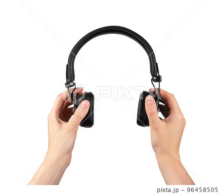 Hands holding headphones isolated on white background. Bluetooth headset. Accessories for leisure, study. Hands holding headphones isolated on white background. Bluetooth headset. Accessories for leisure, study. 96458505
