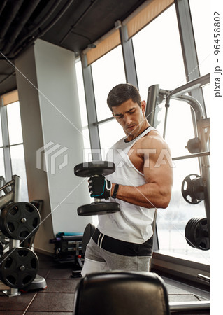 Close up of man using dumbbell exercise at gym, Sport concept 96458802