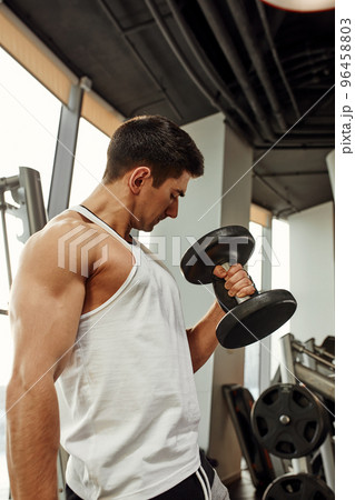 Close up of man using dumbbell exercise at gym, Sport concept 96458803
