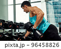 Close up of man using dumbbell exercise at gym, Sport concept 96458826