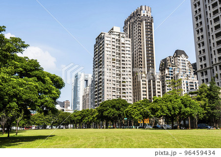 Low-angle view of green park space and modern buildings on both sides in downtown Taichung, Taiwan. here is near the National Taichung Theater. 96459434