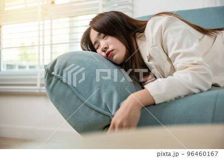 Tired woman sleeping closed eyes on sofa in living room at home after overworked working, Asian female resting falling asleep lying on couch, Close up face Tired woman sleeping closed eyes on sofa in living room at home after overworked working, Asian female resting falling asleep lying on couch, Close up face 96460167