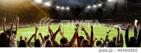 Back view of group of people, football soccer fans cheering at crowded football stadium at evening time. Concept of sport, cup, world, team, event, competition Back view of group of people, football soccer fans cheering at crowded football stadium at evening time. Concept of sport, cup, world, team, event, competition 96460860