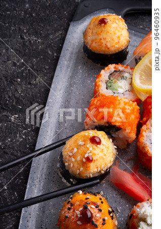 sushi roll set served at grey tray at black table. flat lay. close up sushi roll set served at grey tray at black table. flat lay. close up 96460935