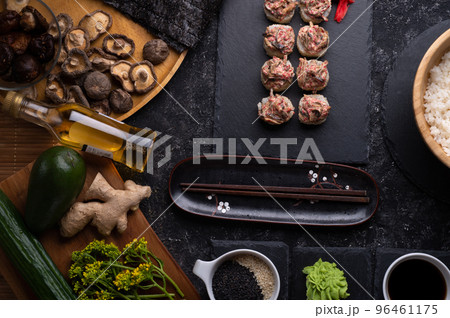 sushi roll set with shiitake mushrooms served  at gblack dish at black table. flat lay 96461175