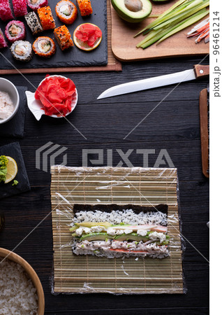 sushi cooking set with rice and ingredients served at black dish at black table. flat lay 96461214