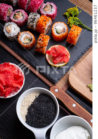 sushi set with ingredients served at black dish at black table. flat lay sushi set with ingredients served at black dish at black table. flat lay 96461237