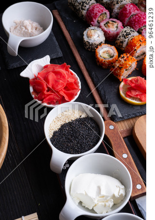 sushi cooking set with rice and ingredients served at black dish at black table. flat lay sushi cooking set with rice and ingredients served at black dish at black table. flat lay 96461239