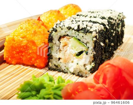 rolls with black roe and sesame and baking sushi on bamboo mat 96461606