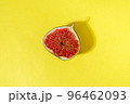 Juicy organic fig cut in half on a yellow background. Minimal summer concept flat lay 96462093