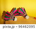 Shuttlecock and racket for playing badminton on a yellow background. Concept summer. Close up 96462095