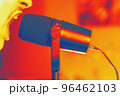 One person sings into the microphone for a copy space. Silhouette of a male singer. Thermography gradients, retro glitch, noise, selective focus 96462103