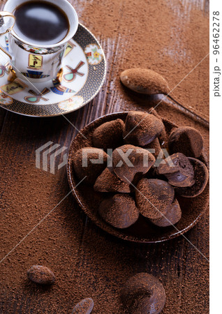 healthy delicious chocolate truffles around ingridients with natural cocoa beans,  powder, cacao butter, cane sugar and cup of coffee. healthy sweets concept. flat lay 96462278