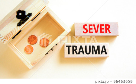 Sever trauma symbol. Concept words Sever trauma on wooden blocks. Beautiful white table white background. Wooden chest with coins. Psychological and sever trauma concept. Copy space. 96463659