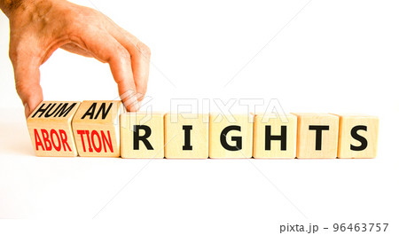 Abortion rights symbol. Concept words Abortion rights are human rights on wooden cubes. Businessman hand. Beautiful white table white background. Business medical abortion rights concept. Copy space. Abortion rights symbol. Concept words Abortion rights are human rights on wooden cubes. Businessman hand. Beautiful white table white background. Business medical abortion rights concept. Copy space. 96463757