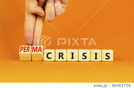 Permacrisis or crisis symbol. Concept words Crisis and Permacrisis on wooden cubes. Businessman hand. Beautiful orange table orange background. Business permacrisis or crisis concept. Copy space. 96463759