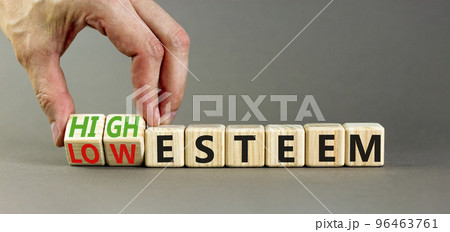 High or low esteem symbol. Concept words High esteem and Low esteem on wooden cubes. Businessman hand. Beautiful grey table grey background. Business high or low esteem concept. Copy space. High or low esteem symbol. Concept words High esteem and Low esteem on wooden cubes. Businessman hand. Beautiful grey table grey background. Business high or low esteem concept. Copy space. 96463761
