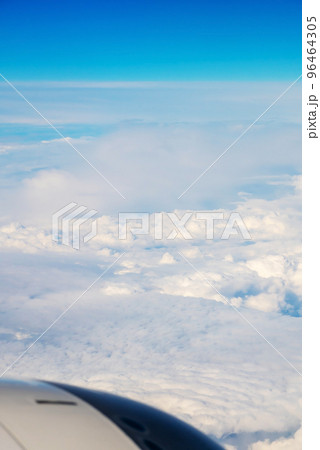 View from Boeing 737 MAX 8 on White Air Clouds And Clear Blue Sky. In frame White-Grey Engine Casing With Vanes. View from Boeing 737 MAX 8 on White Air Clouds And Clear Blue Sky. In frame White-Grey Engine Casing With Vanes. 96464305