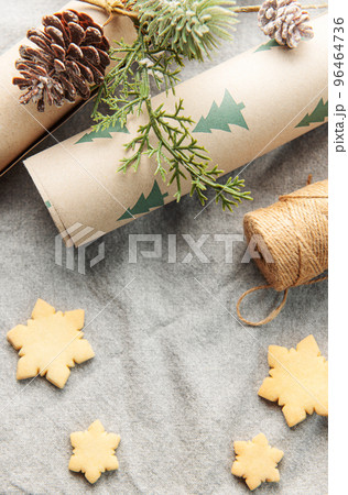Wrapping paper with a pine branch and Christmas cookies on a textile background Wrapping paper with a pine branch and Christmas cookies on a textile background 96464736