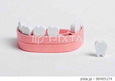 Wooden jaw model and baby losing milk tooth. Primary, deciduous teeth loss. Oral hygiene, dental care concept. Children game at dentist 96465174