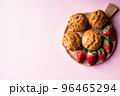 Strawberry muffins on a wooden board on a pink background. 96465294
