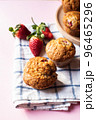 Strawberry muffins on a napkin on a pink background. Close up. 96465296