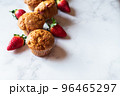 Strawberry muffins on a white marble background. Top view and copy space. 96465297