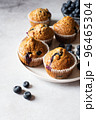 Blueberry muffins  served on a white plate on a marble background. 96465304