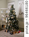 Christmas tree with presents underneath in living room 96466180