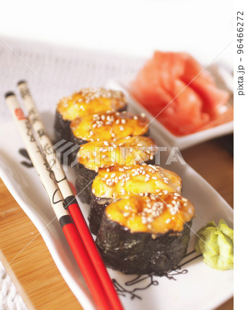 hot sushi with roe and chopsticks. close up hot sushi with roe and chopsticks. close up 96466272