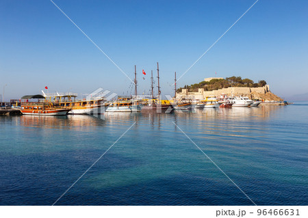 Boats at Marina with Castle on the Coast in a Touristic Town by the Aegean Sea. Kusadasi, Turkey Boats at Marina with Castle on the Coast in a Touristic Town by the Aegean Sea. Kusadasi, Turkey 96466631