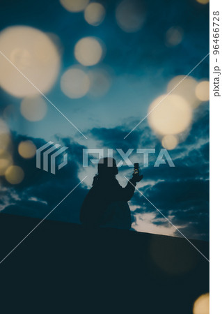海辺で佇む若い女性のシルエット写真 96466728