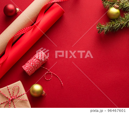 Christmas preparation, boxing day and holidays gift giving, xmas craft paper and ribbons for gifts boxes on red background as wrapping tools and decorations, diy presents as holiday flat lay design Christmas preparation, boxing day and holidays gift giving, xmas craft paper and ribbons for gifts boxes on red background as wrapping tools and decorations, diy presents as holiday flat lay design 96467601
