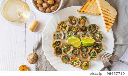 Limpets molluscs with lime and a glass of whine 96467710