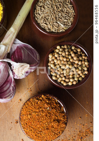 Spices and herbs in ceramic bowls. Food and cuisine ingredients. Colorful natural additives. Spices and herbs in ceramic bowls. Food and cuisine ingredients. Colorful natural additives. 96468556