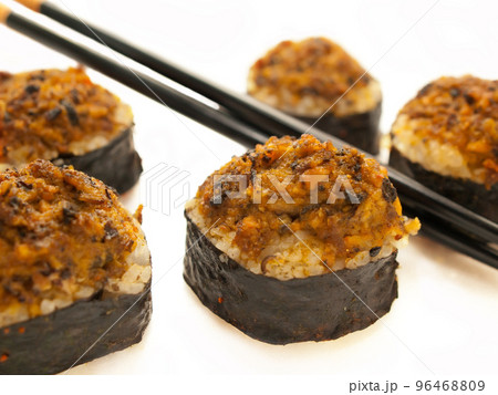 baked sushi rolls with mussels and chopsticks closeup over white baked sushi rolls with mussels and chopsticks closeup over white 96468809