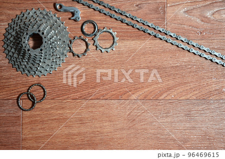 Some composition of a bicycle chain, several sprockets and other components of a sports bike Some composition of a bicycle chain, several sprockets and other components of a sports bike 96469615