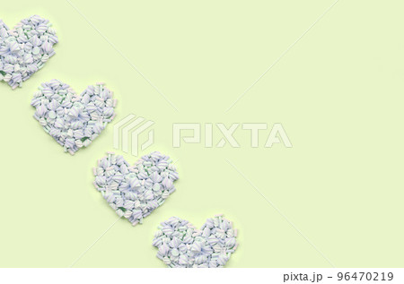 Colorful marshmallow laid out on lime and pink paper background. pastel creative textured hearts 96470219