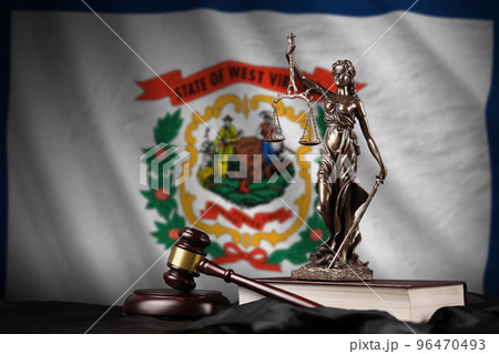 West Virginia US state flag with statue of lady justice, constitution and judge hammer on black drapery. Concept of judgement and guilt West Virginia US state flag with statue of lady justice, constitution and judge hammer on black drapery. Concept of judgement and guilt 96470493