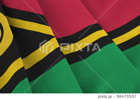 Vanuatu flag with big folds waving close up under the studio light indoors. The official symbols and colors in banner Vanuatu flag with big folds waving close up under the studio light indoors. The official symbols and colors in banner 96470507