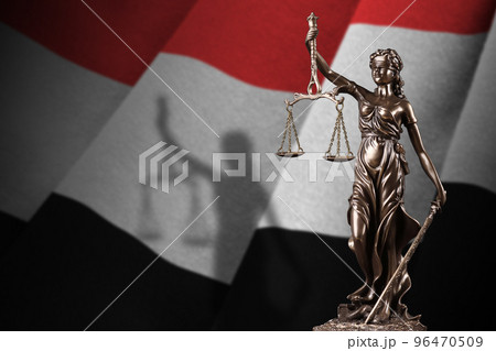 Yemen flag with statue of lady justice and judicial scales in dark room. Concept of judgement and punishment 96470509