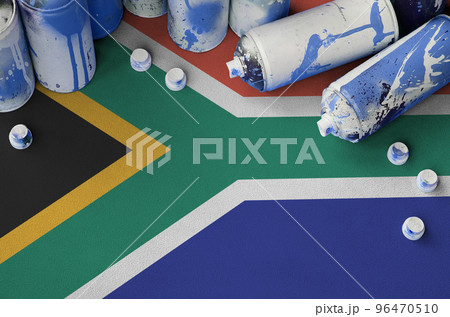South Africa flag and few used aerosol spray cans for graffiti painting. Street art culture concept South Africa flag and few used aerosol spray cans for graffiti painting. Street art culture concept 96470510