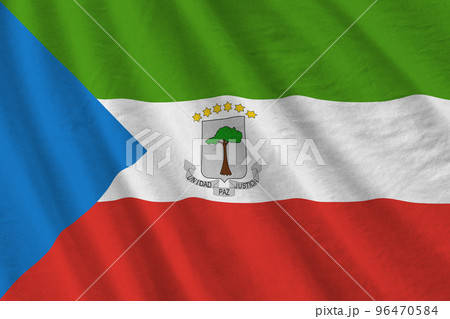 Equatorial Guinea flag with big folds waving close up under the studio light indoors. The official symbols and colors in banner 96470584