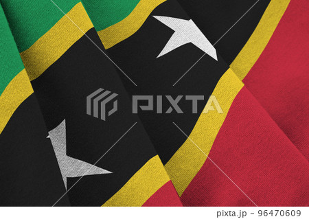 Saint Kitts and Nevis flag with big folds waving close up under the studio light indoors. The official symbols and colors in banner 96470609