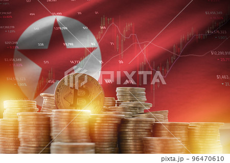 North Korea flag and big amount of golden bitcoin coins and trading platform chart. Crypto currency 96470610