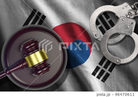 South Korea flag with judge mallet and handcuffs in dark room. Concept of criminal and punishment, background for judgement topics 96470611