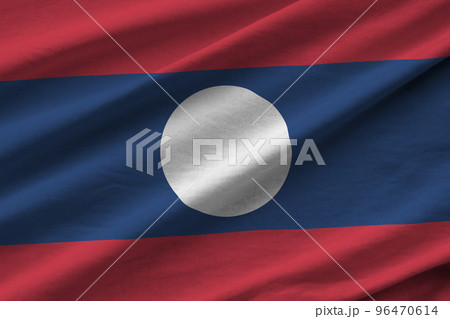 Laos flag with big folds waving close up under the studio light indoors. The official symbols and colors in banner 96470614