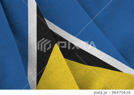 Saint Lucia flag with big folds waving close up under the studio light indoors. The official symbols and colors in banner 96470616