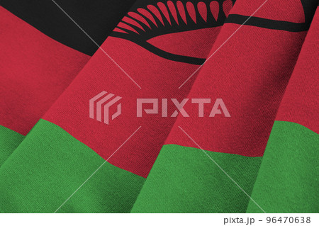 Malawi flag with big folds waving close up under the studio light indoors. The official symbols and colors in banner 96470638
