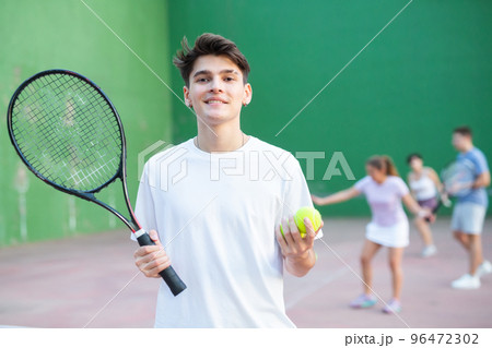 Portrait of caucasian man frontenis player in outdoor court Portrait of caucasian man frontenis player in outdoor court 96472302